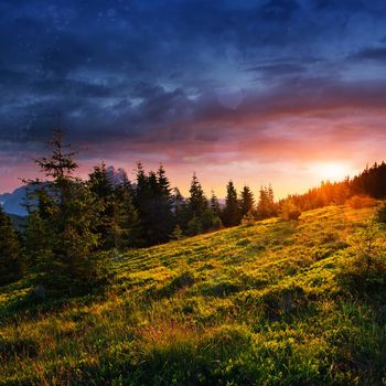 Beautiful summer mountain landscape. Blue color of mountains during sunset. Dramatic scene. Carpathian, Ukraine, Europe. Artistic picture. Soft filter effect.