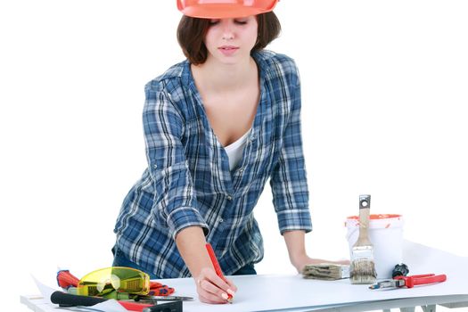 woman builder smiling in an orange helmet on a light background portrait