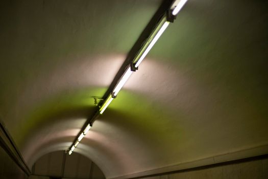 Lamps on ceiling of tunnel. Details of interior of metro. Fluorescent lamp.