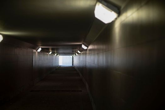 Tunnel with lamps. Long tunnel in building. Subway.