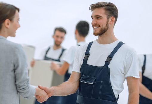 Manager with clipboard shaking hands with movers.