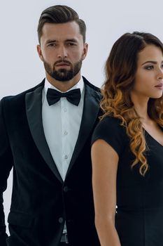Fashion photo of a beautiful elegant man in a suit with a beautiful sexy woman posing on a white studio background