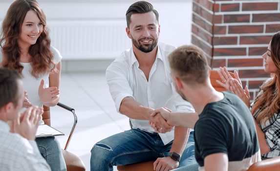 friendly handshake colleagues when meeting at the workshop