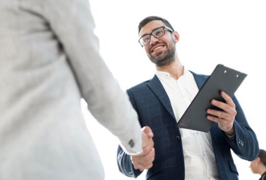 close up. smiling businessman shaking hands with a business woman