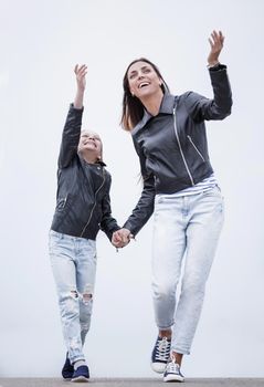 in full growth.happy mother and daughter walking together.photo with copy space