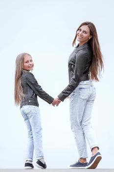 rear view. happy mother and daughter walk together. photo with copy space