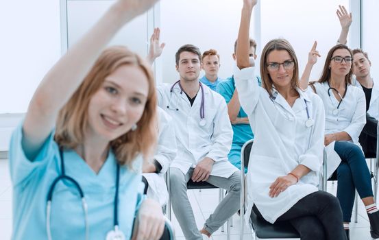 close up. young doctors raise their hands to ask questions. photo with copy space