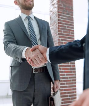 business leader shaking hands with partner.vertical photo