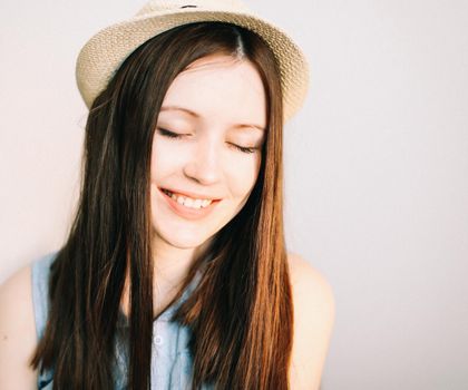 Beautiful young smiling happy woman wearing summer hat.