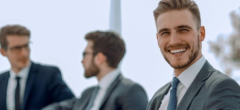 smiling businessman in the background of the office.photo with copy space