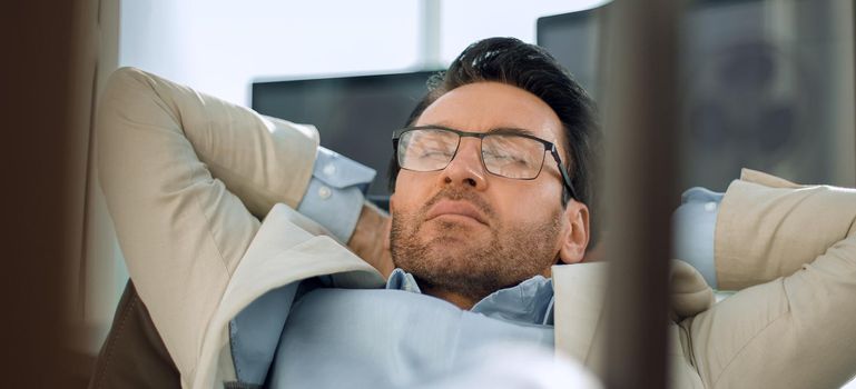 relaxing businessman sitting at his Desk. photo with copy space