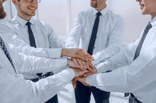 successful employees put their hands together.the concept of teamwork