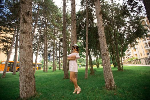 Beautiful girl in the park. Green grass and sunny weather.