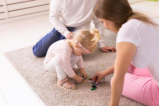 Cochlear implant on the child girl head and playing with mother and father. Hearing aid and deafness and innovative health technology