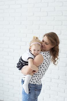 Mother holds her child with hearing aids and cochlear implants . Deaf and health