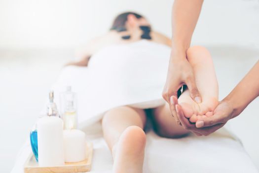 Foot spa massage treatment by professional massage therapist in luxury spa resort. Wellness, stress relief and rejuvenation concept.