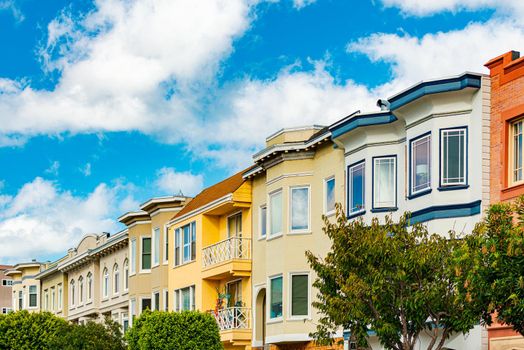 Old houses in San Francisco, California, Unites States of America. Blue cloudy sky in background.