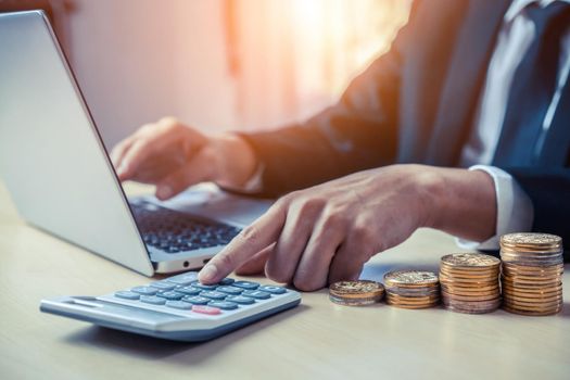Businessman accountant or financial expert analyze business report graph and finance chart at corporate office. Concept of finance economy, banking business and stock market research.