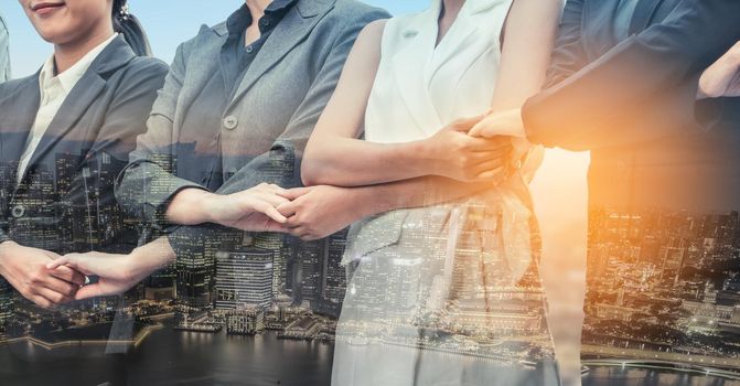 Double exposure business people holding hands together showing workers relationship, unity and teamwork. Human resources and people recruitment concept.