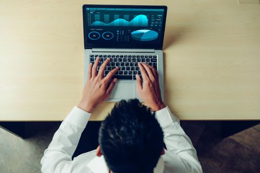 Business data dashboard analysis by ingenious computer software . Investment application display business sales and profit on the computer screen and advise marketing planning decision .