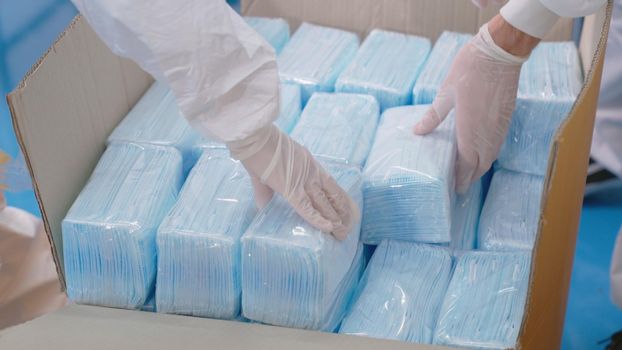 Face mask production line in modern factory . Concept of covid-19 coronavirus 2019 provention .