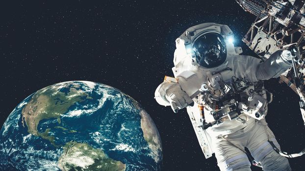 Astronaut spaceman do spacewalk while working for spaceflight mission at space station . Astronaut wear full spacesuit for operation . Elements of this image furnished by NASA space astronaut photos .