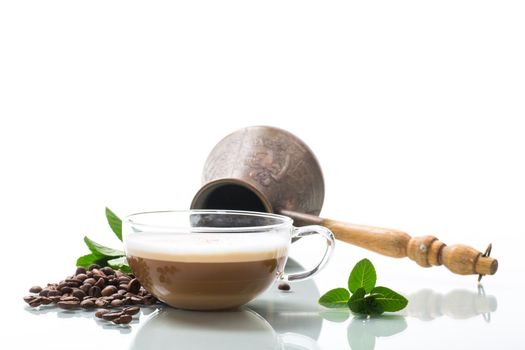 Cup of coffee latte with heart shape and coffee beans isolated on white background