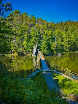 Long steel hanging footbridge over Modre lake