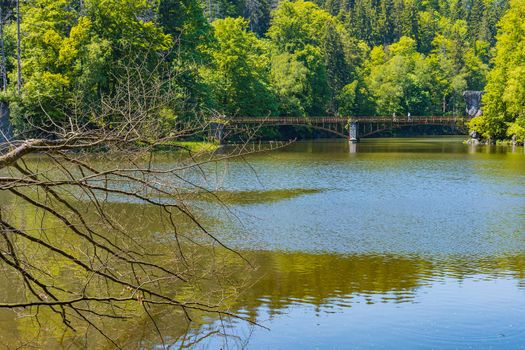 Long steel hanging footbridge over Modre lake