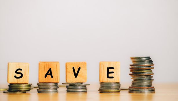 The word SAVE is written from a wooden block or cube to save money invest for future. Concept for loan, property ladder, financial, real estate investment, taxes and bonus.