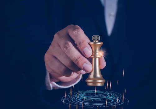 Businessman holding and throwing golden king chess to target for business winner with successfully in the competition with technology network background. Management and leadership strategy concept.