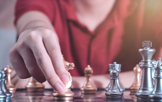 Hand of confident boy moving pawn chess to development in competition success play which new strategy plan, leader and teamwork, network learning tactics and analysis concept.