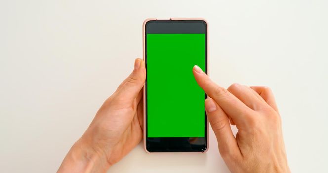 Scroll on Smartphone with Green Mock-up Screen Chroma Key. Phone green screen for product placement. Gestures on touch screen.