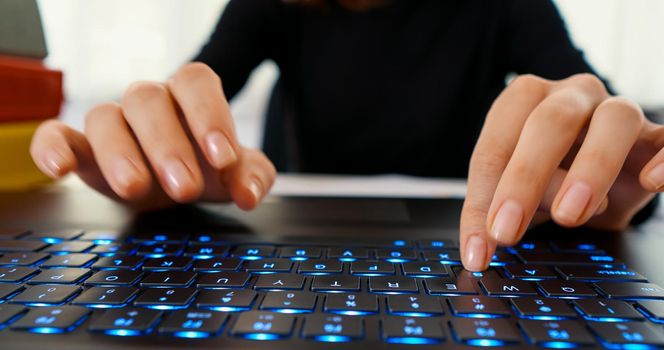 Woman hands typing on laptop. Keyboard typing hands. Office work. Setting goals. Writes mails, research, surfing internet. Business and finance sheets.