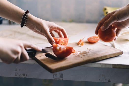 Man and woman preparing a vegetable salad close up