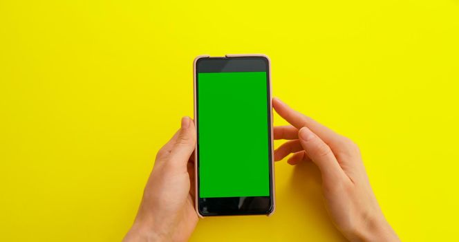 Scroll on Smartphone with Green Mock-up Screen Chroma Key. Phone green screen for product placement. Gestures on touch screen.