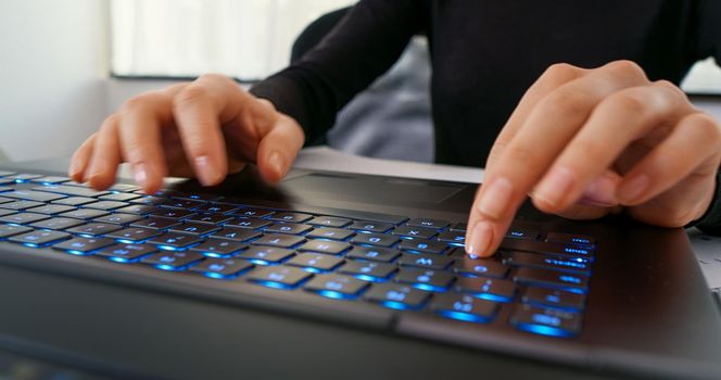 Female hands texting on laptop keyboard close up. Busy business woman emailing use digital wireless portable device. Office work, software, online education, apps, modern tech concept.