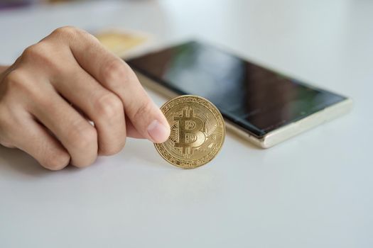 Cryptocurrency is digital currency, women hold their hands on computer ready bitcoin coins to invest assets from the digital or imaginary world of the future. , finance, investment, risk management.