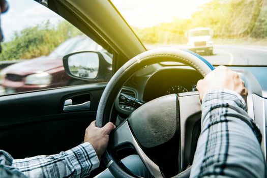 Close up of man's hands on the wheel, a person driving with hands on the wheel, A man with hands on the wheel of the car, Concept of hands on the wheel of a car