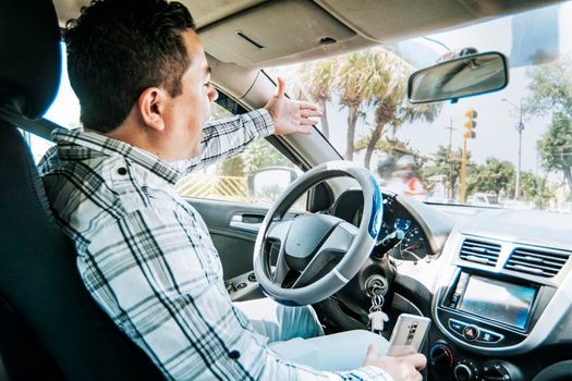 Stressed driver man yelling at other driver, Impatient driver yelling, portrait of angry driver yelling in his car, concept of impatient driver yelling