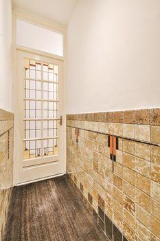 Corridor of contemporary apartment with doorway leading to terrace