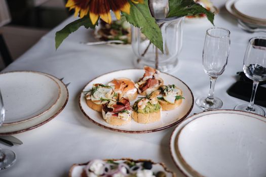 Delicious bruschettas on a white plate.