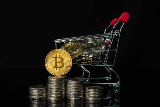 Close up Bitcoin coin and coin in shopping cart with black background