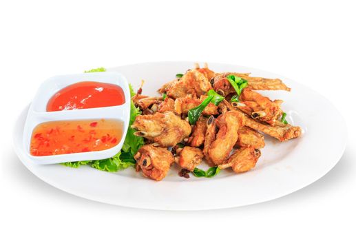 Fried chicken wings with sauce in white plate on white background