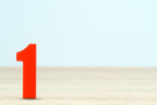 Shot of a number one made of red plastic on table with copy space