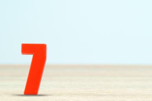 Shot of a number seven made of red plastic on table with copy space