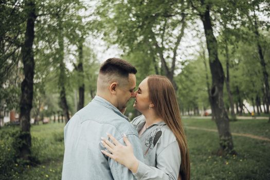 loving couple walking in ukrainian park and city