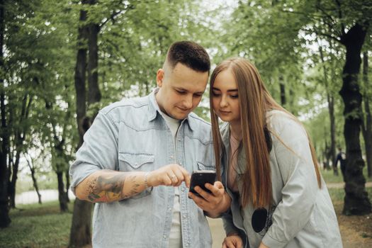 loving couple walking in ukrainian park and city