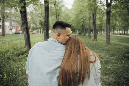 loving couple walking in ukrainian park and city