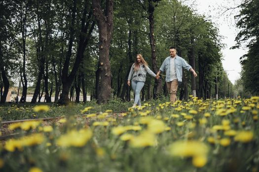 loving couple walking in ukrainian park and city